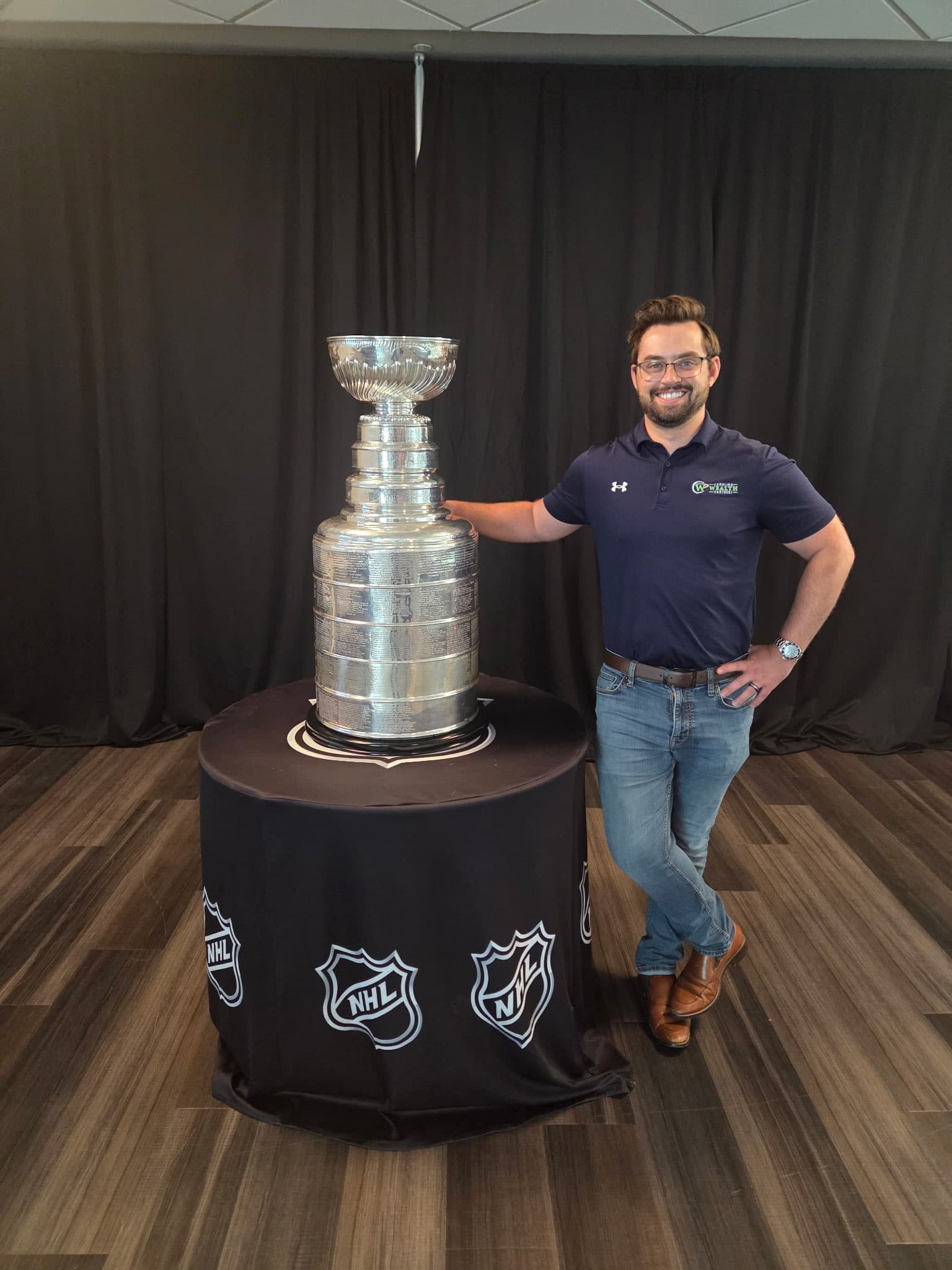 Mitchell Ludwig standing beside the Stanley Cup
